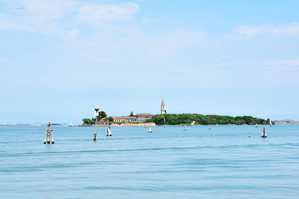 Poveglia, a small island located between Venice and Lido in the Venetian Lagoon, Italy, as seen from Malamocco on Lido Island. It was used as a quarantine station in history.
