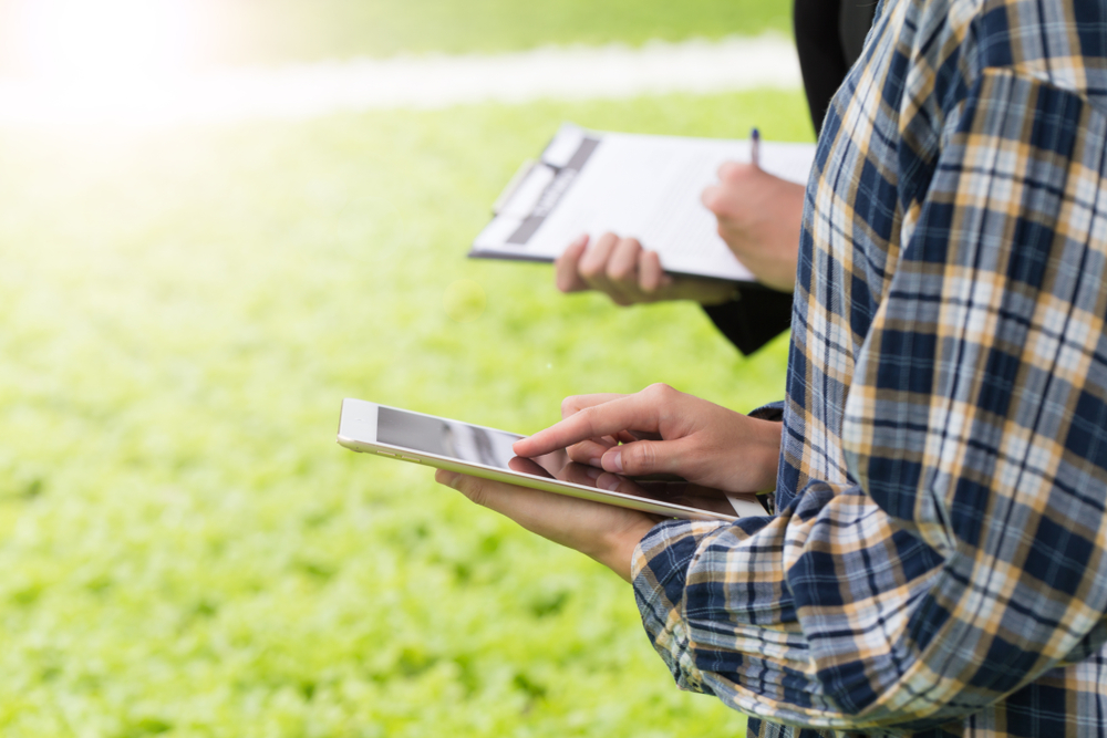 close up farmer checking agriculture's quality by using tablet technology to control.
