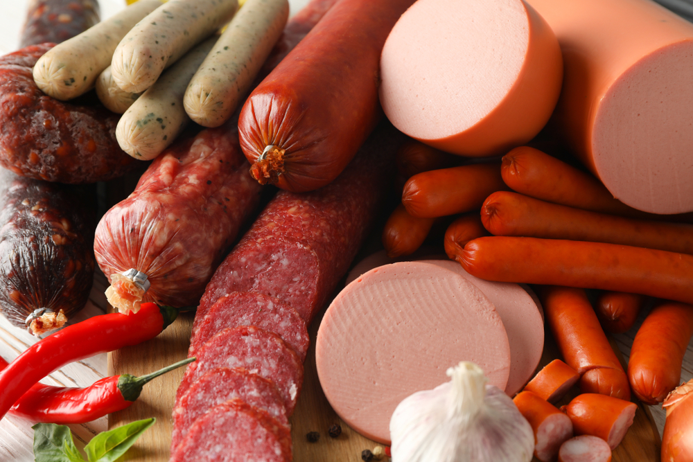 Sausage and spice on wooden background, close up