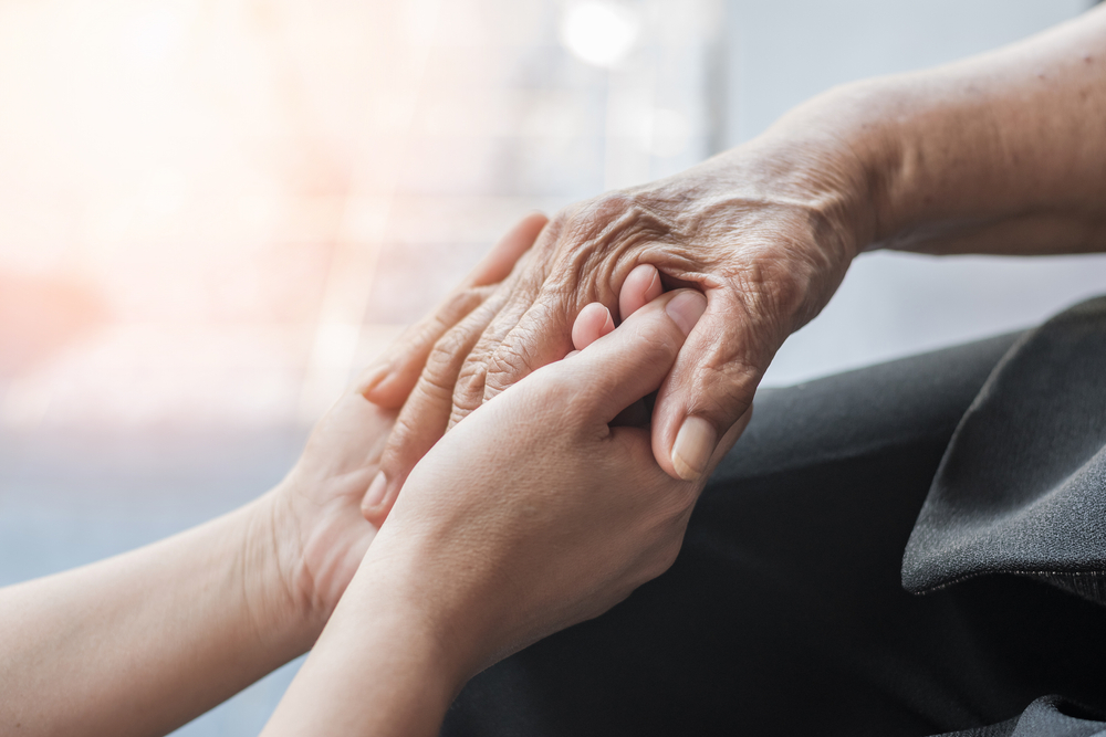 Parkinson disease patient, Alzheimer elderly senior, Arthritis person's hand in support of nursing family caregiver care for disability awareness day, National care givers month, ageing society
