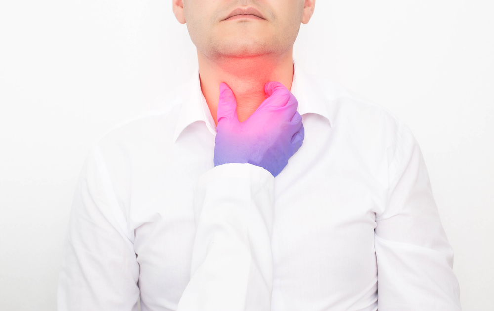 The doctor checks during the examination of the thyroid gland in a man on a white background. Concept of Thyroid Disease in Men, Nodular Goiter and Cancer, thyrotoxicosis