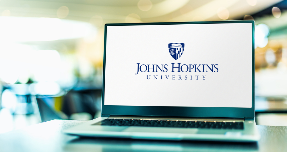 POZNAN, POL - APR 20, 2021: Laptop computer displaying logo of The Johns Hopkins University, a private research university in Baltimore, Maryland
