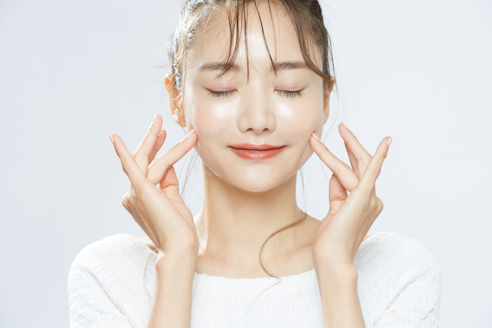 Beauty portrait of a young Asian woman with bun hair

