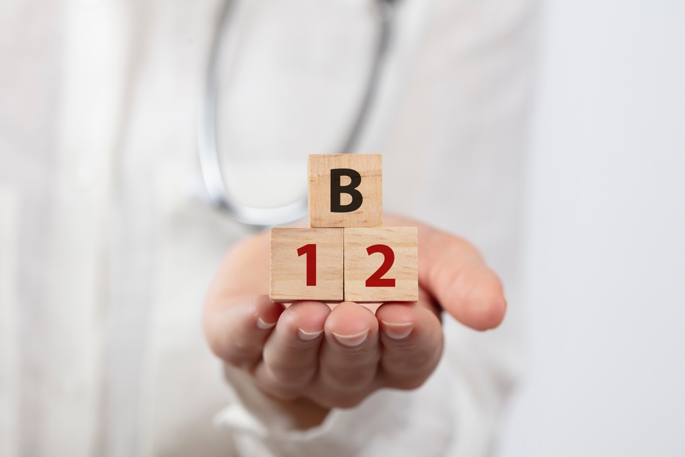 a doctor is holding vitamin B12 on white background. Health Concept.