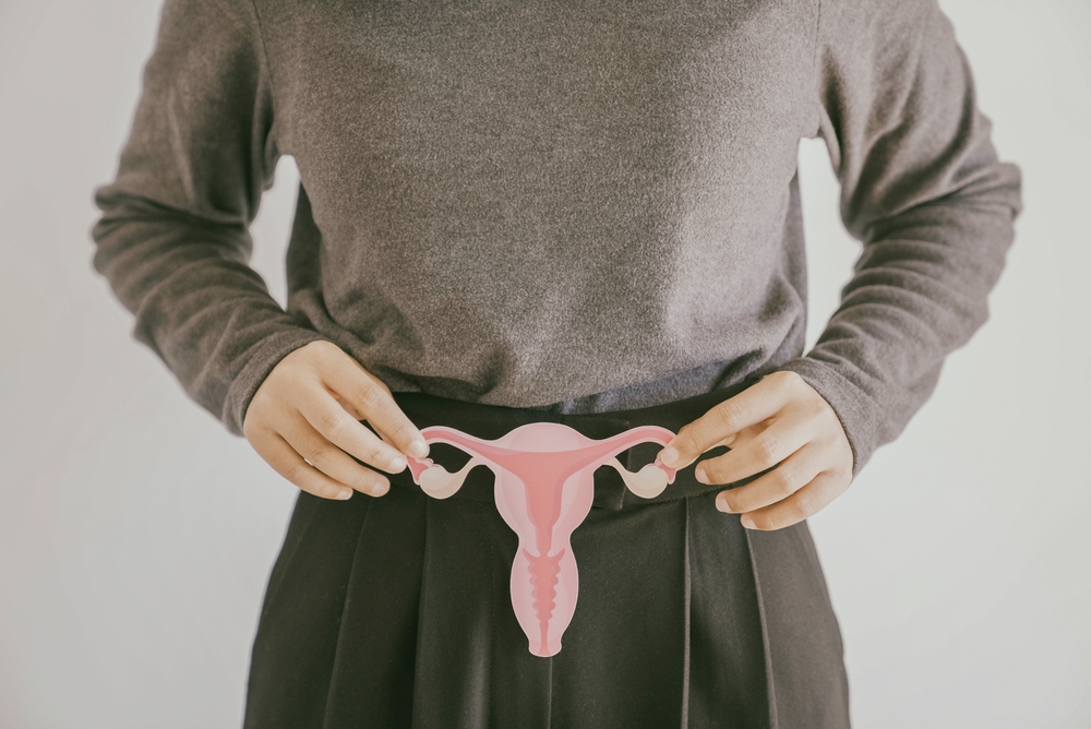 Woman hands holding uterus, female reproductive system , woman health, PCOS, gynecologic and cervical cancer concept