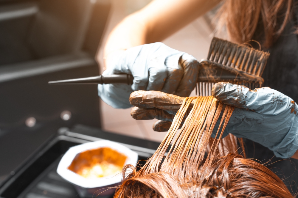 Hair Coloring In A Beauty Salon. Professional wizard paints the hair in the salon. Beauty concept, hair care. Hairdressing Services