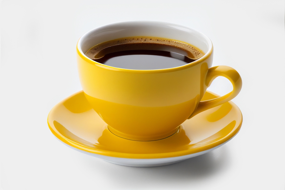Close up yellow cup of black coffee isolated on white background with clipping path. A mug of coffee.