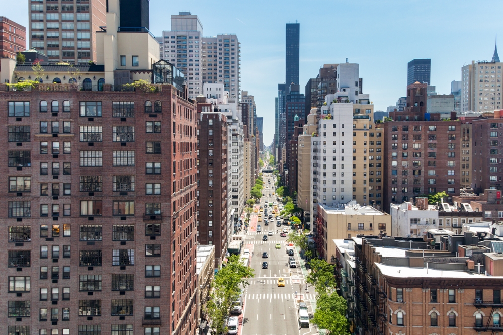 Overhead view First Avenue with traffic drivings through the buildings of Manhattan in New York City, as seen from the Roosevelt Island Tramway

