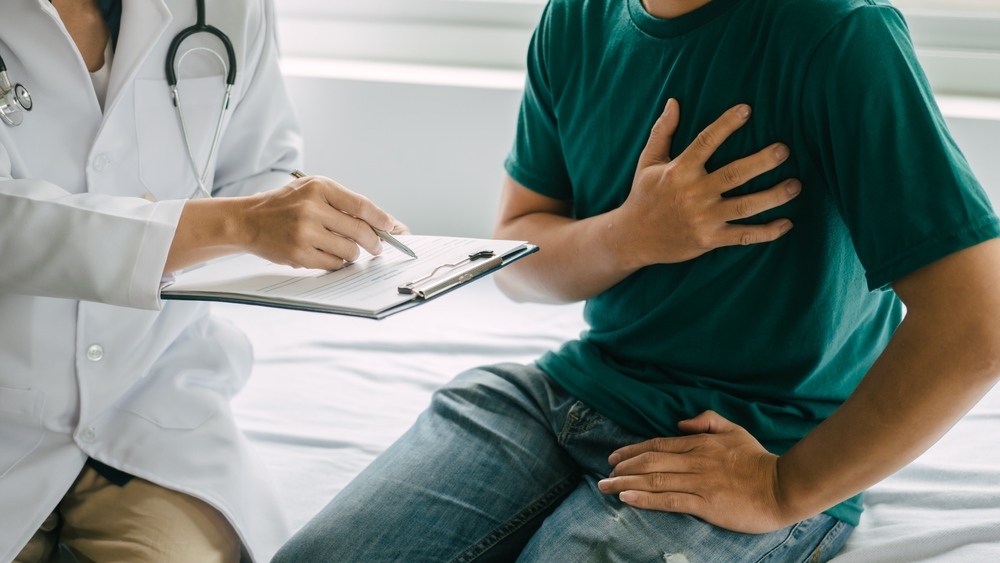 Male patient consulting a medical specialist at hospital. Chest pain and inflammatory heart disease