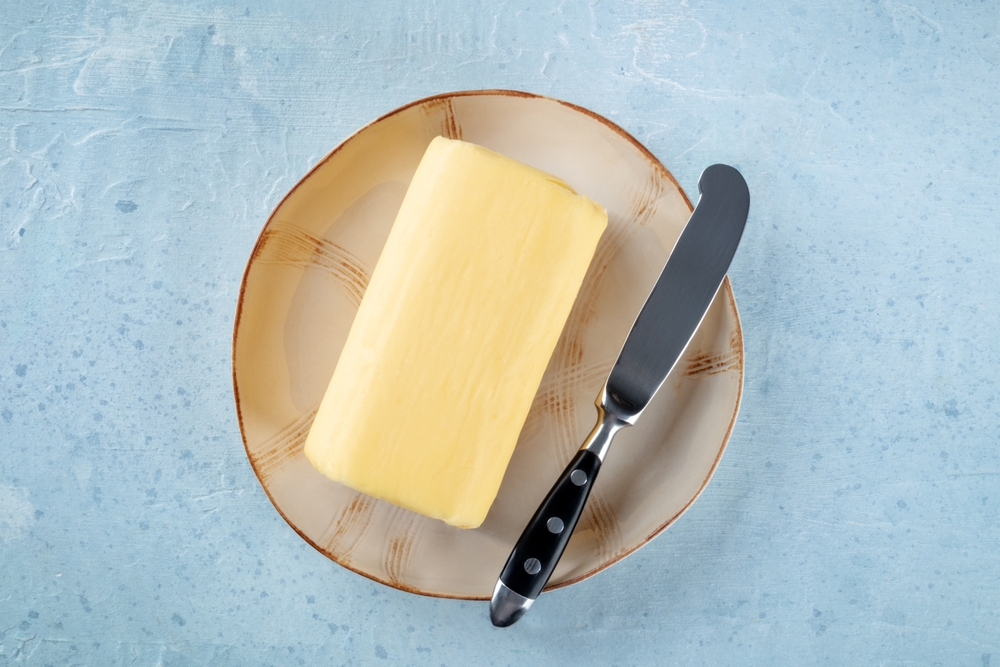 Pieces of butter A bowl of yellow butter cubes. To make butter cubes, take a frozen block of butter and place it on a chopping board.
