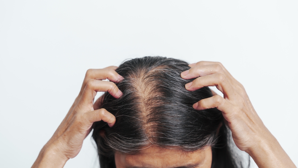 Close up older elderly asian chinese woman gray hair worry cancer worry about hair loss