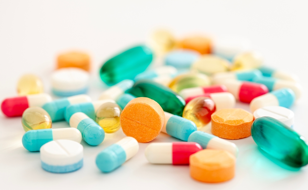 Pills, different colors, with selective focus.