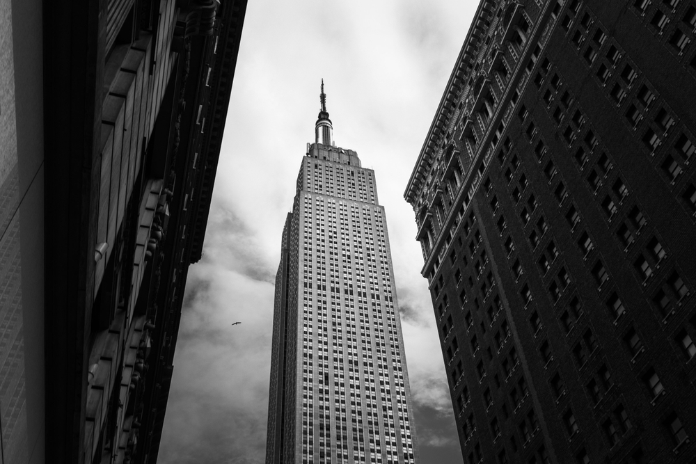 A low angle shot of the Empire State building of New York City, USA in grayscale
