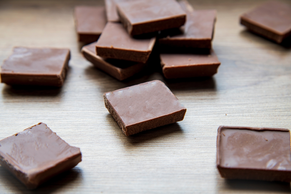 Dark chocolate on wooden table...a cube of chocolate...chocolate day...