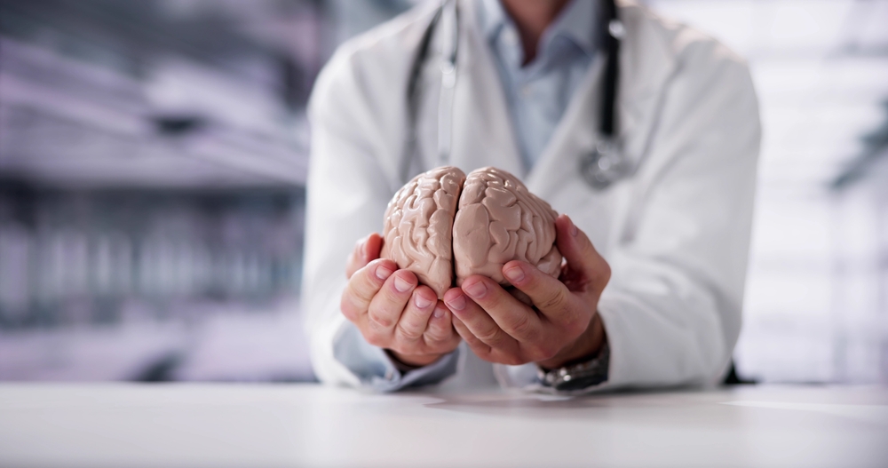Close-up Of A Doctor's Hand Holding Human Brain Model