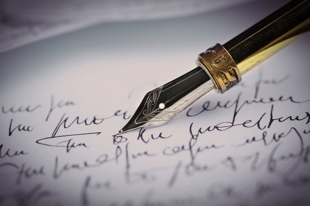 Writing letter with fountain pen, closeup view
