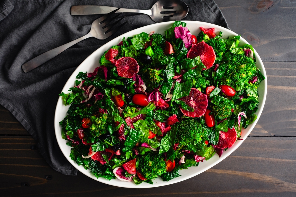 Blood Orange and Tuscan Kale Salad Arranged on a Large Platter: Fresh salad made with kale, broccoli, and radicchio topped with olive oil dressing