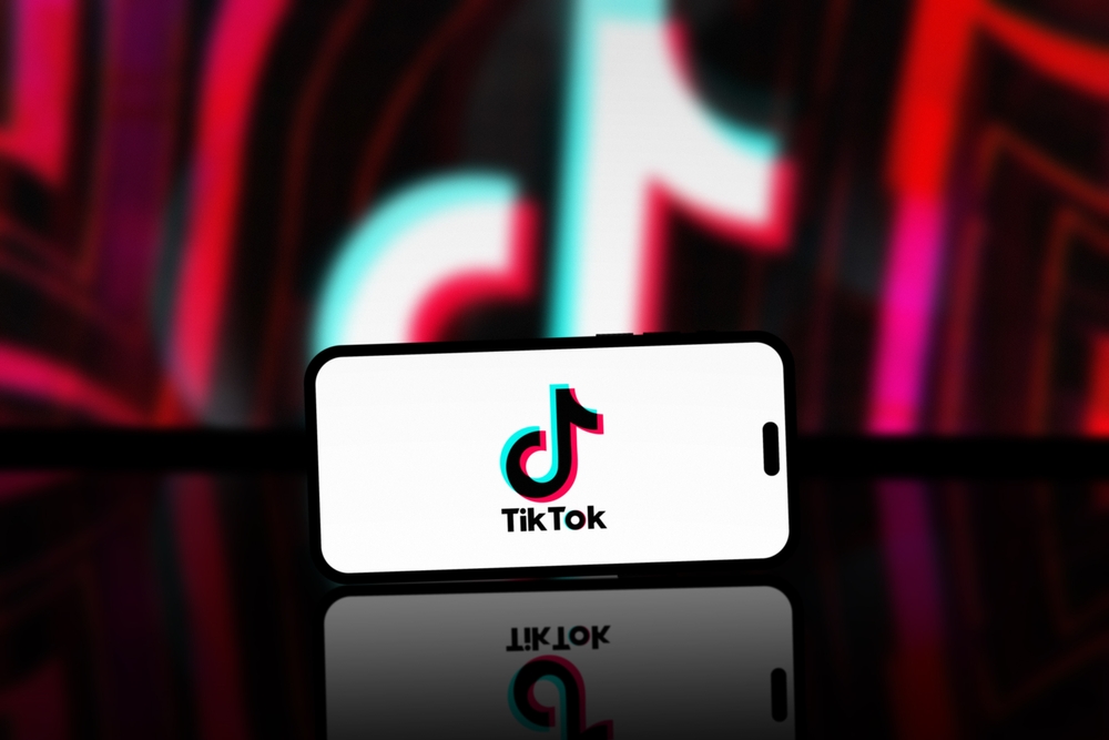 Washington, United States - April 04 2024: TikTok App is displayed on smartphone screen, TikTok logo is blurred in the background. A popular short videos social network on the internet.
