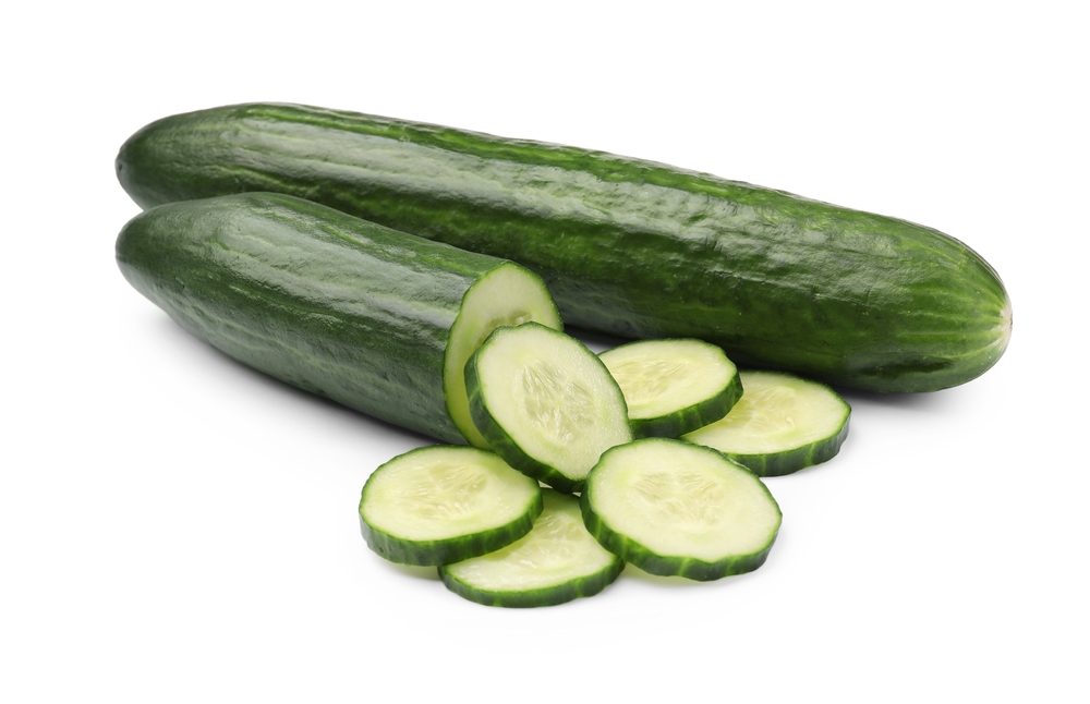 Whole and cut long cucumbers isolated on white