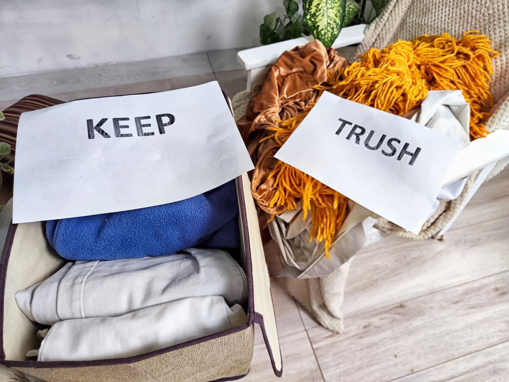 Decluttering Essentials Using the KonMari Method. Assorted items sorted into categories labeled Keep, Trash and Donate
