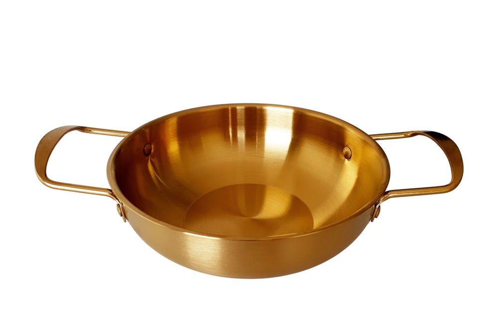 Empty Golden Pan or Brass Pan with handles isolated on white background with clipping path. Empty Korean Gold Noodle Ramen Pot. Mock up template for food poster design.