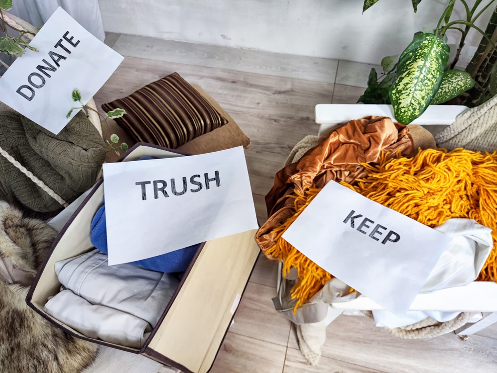 Decluttering dress according to the Konmari method. The various products are sorted into categories marked Save, Discard, Donate
