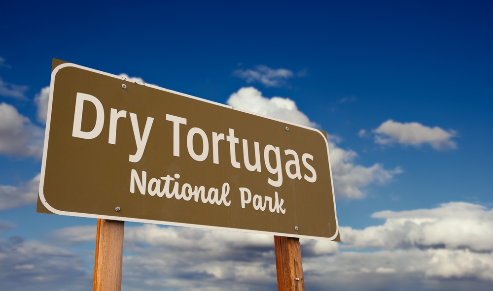 Dry Tortugas National Park (Florida) Road Sign Against Blue Sky and Clouds.
