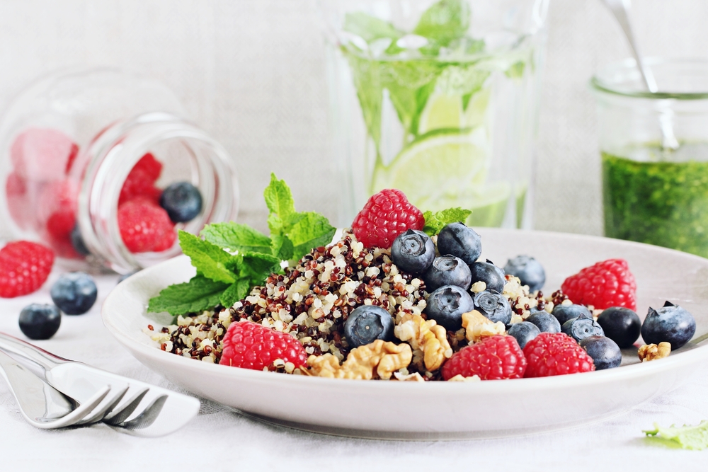 Quinoa salad with fresh raspberries,blueberries,walnuts and mint lime honey dressing.Superfoods and clean eating concept .Selective focus.