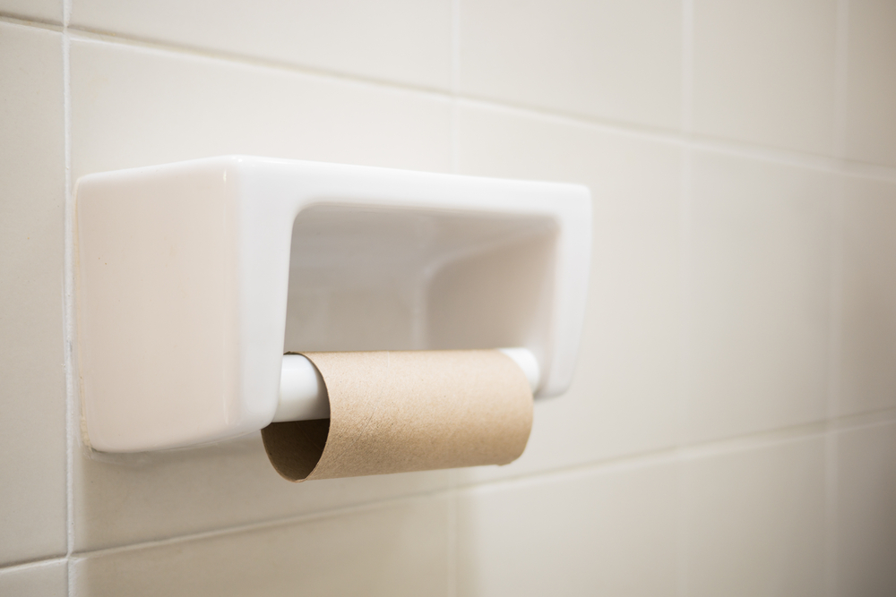 empty toilet paper roll in restroom, selective focus

