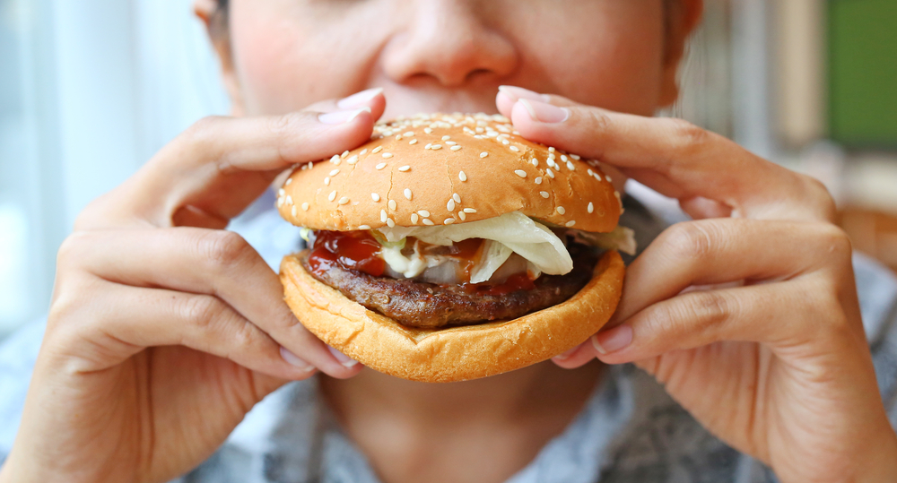 Woman eating beef berger