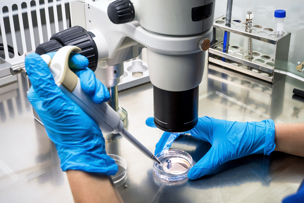 Researcher using microscope in laboratory, cancer research in modern lab. Medical test with pipette in clinic. Development of medicine, new drug. Scientific study of cancer, corona and monkeypox virus