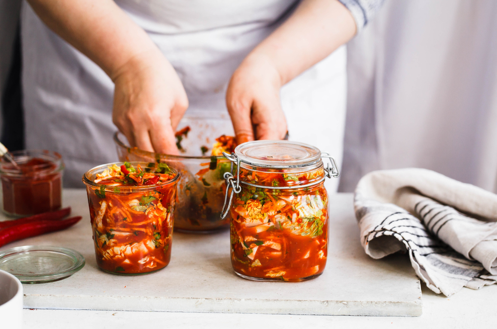 Base Cabbage Kimchi. Person preparing cabbage kimchi. Fermented and vegetarian preserved food concept.

