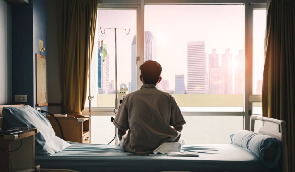 patient sat on the bed and looked out the window in the hospital alone and had stress, boredom, loneliness, anxiety. / Health care and medical
