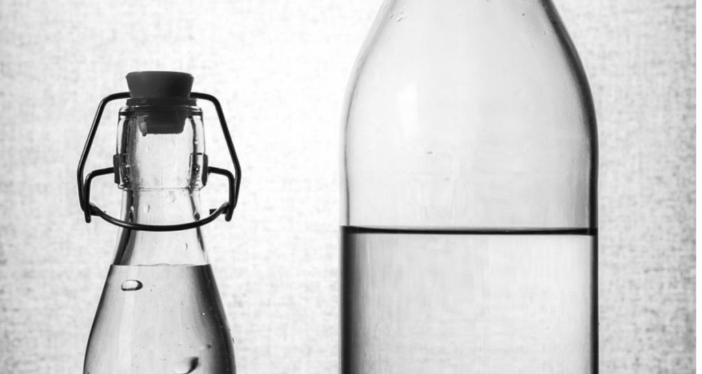 Close up of water in glass bottles.