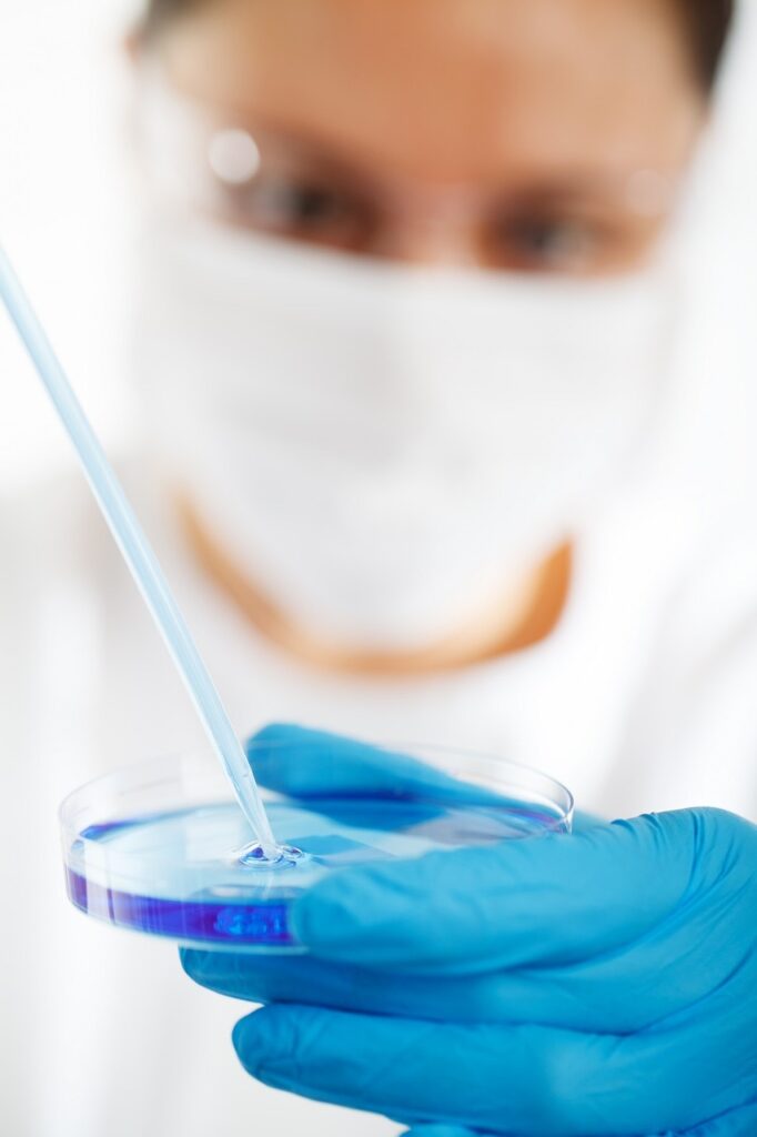 A medical professional holding a test kit. 