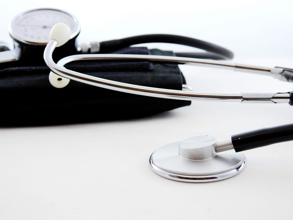 A stethoscope and blood pressure cuff. White background. 