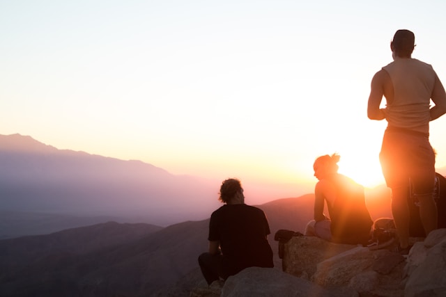 people hiking at sunset 