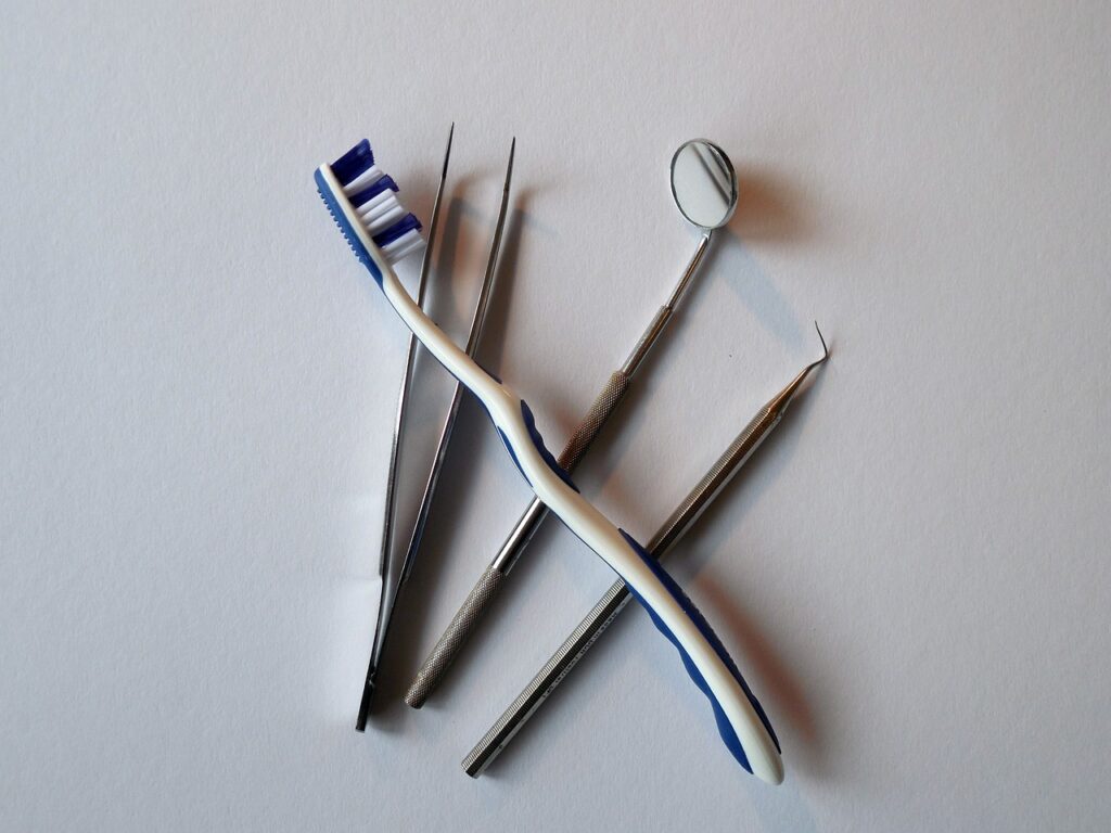 Dental tools and a toothbrush. White background.