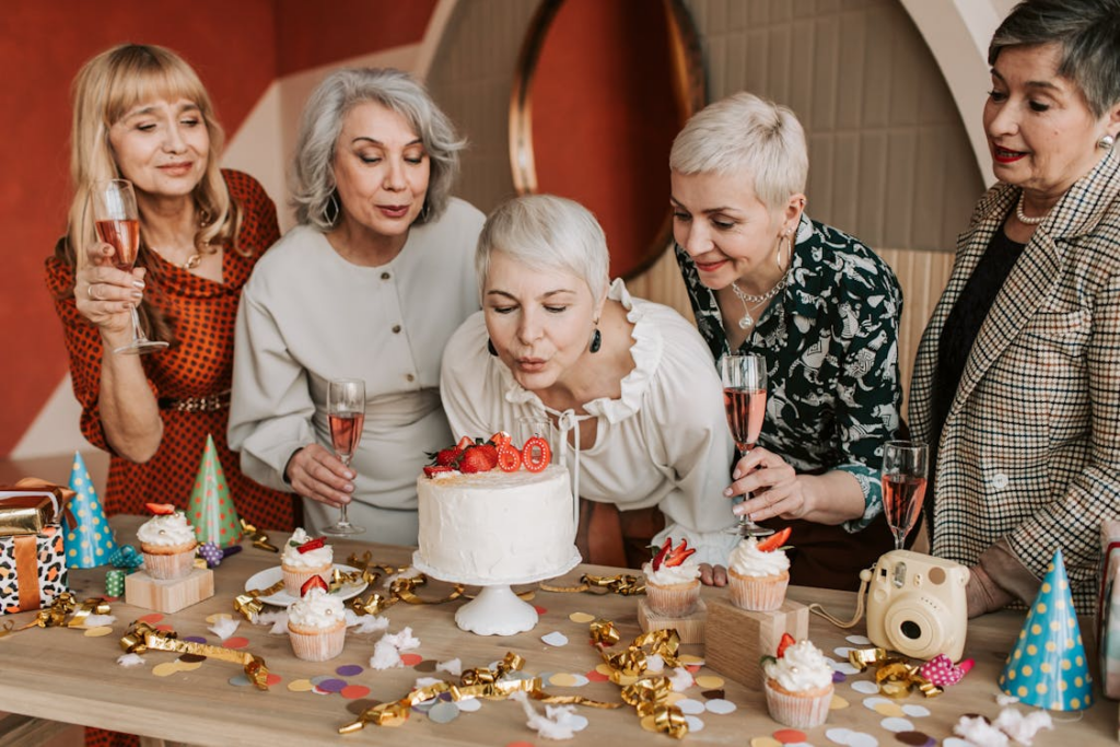 Woman blowing out candles on cake