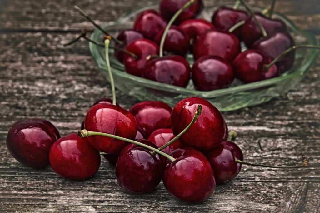 group of cherries in a bowl