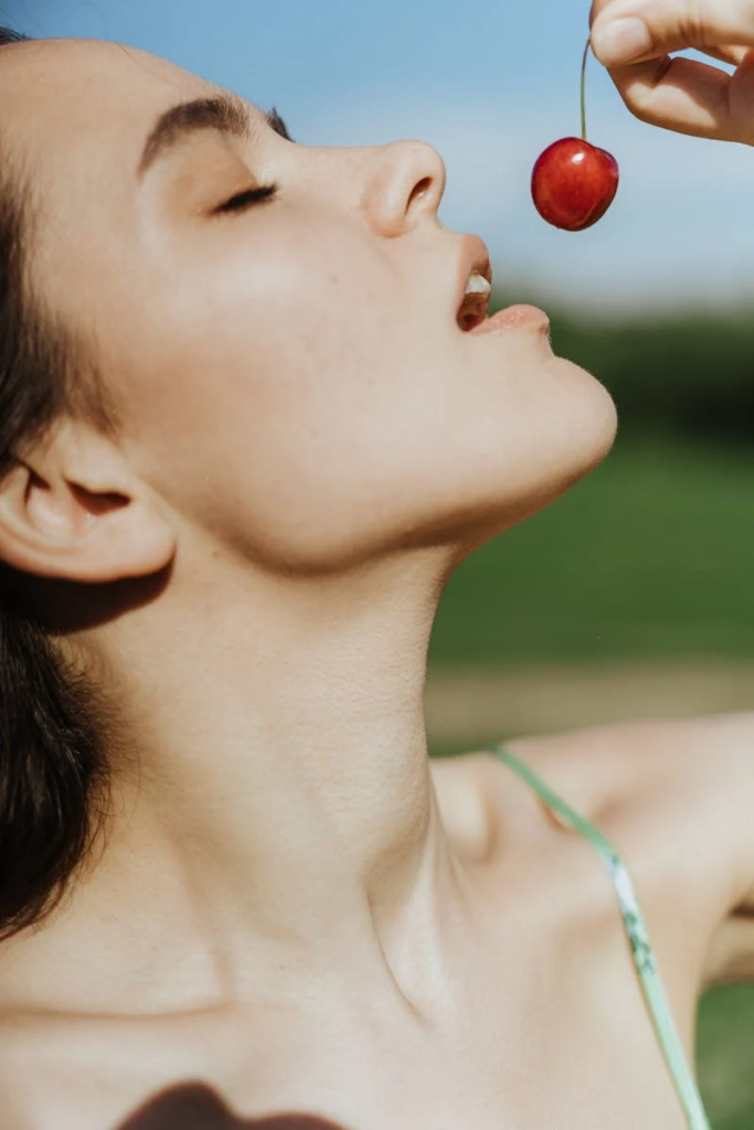 woman eating a cherry
