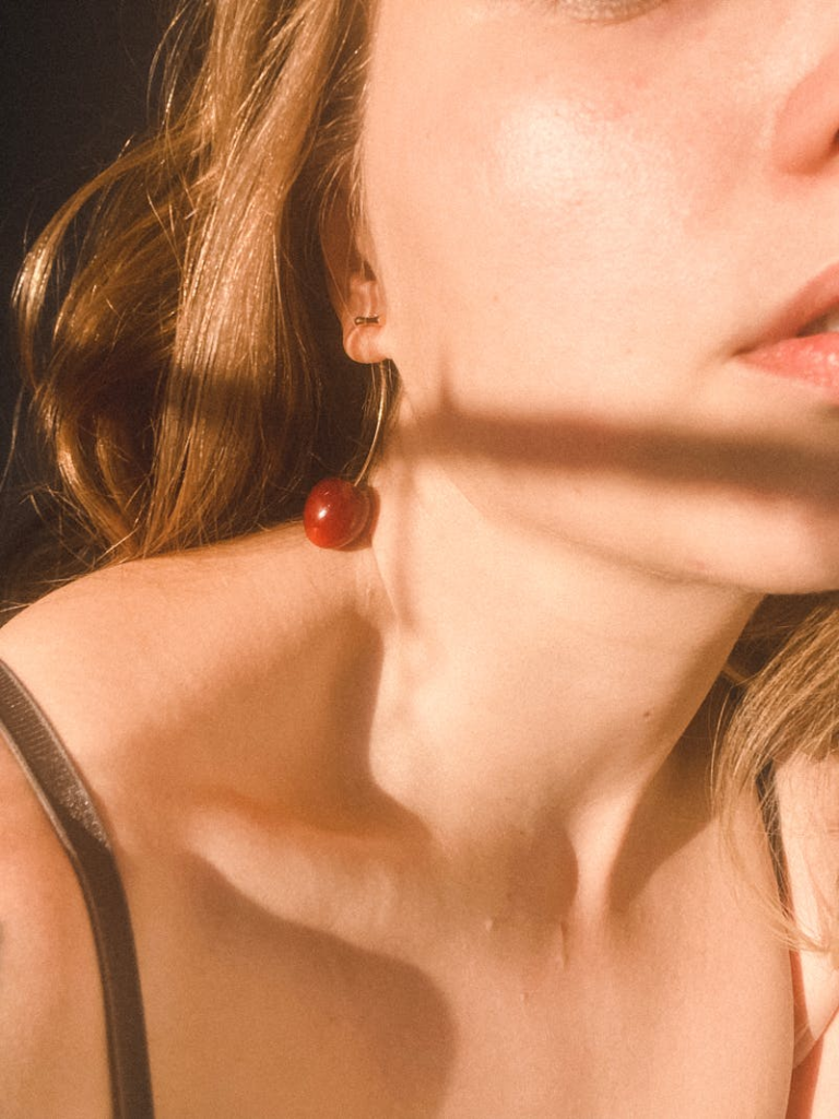 woman wearing cherry earrings