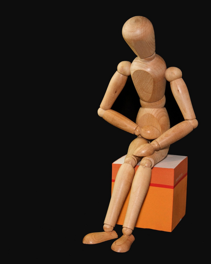 A stick figure holding their stomach