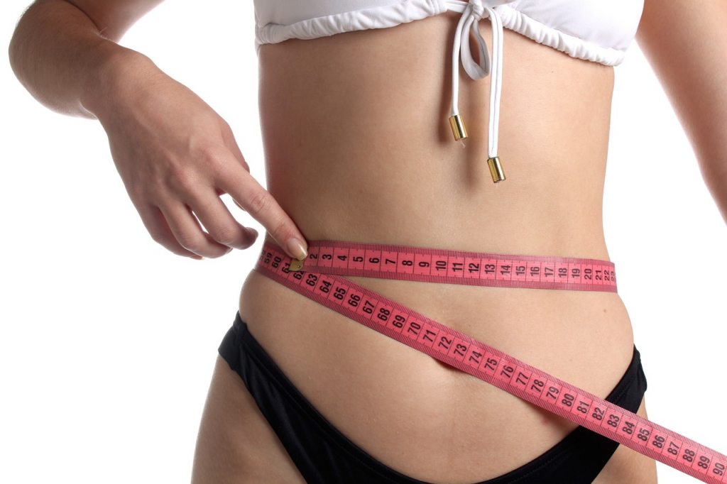 women with a ruler around her waist
