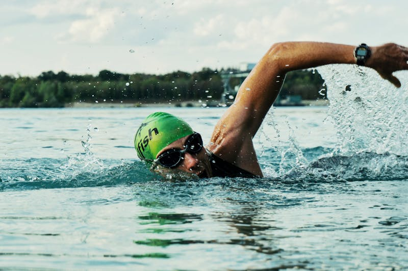 man going for a swim in a lake