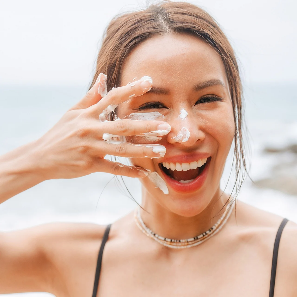woman applying sunscreen