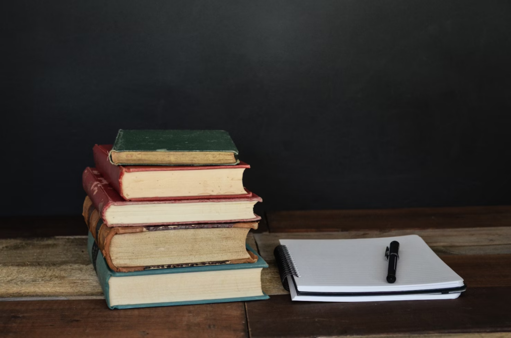 Books, notepad, and a pen