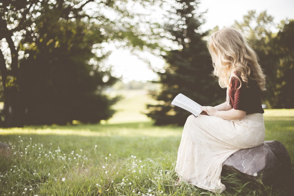 Girl reading in a meadow