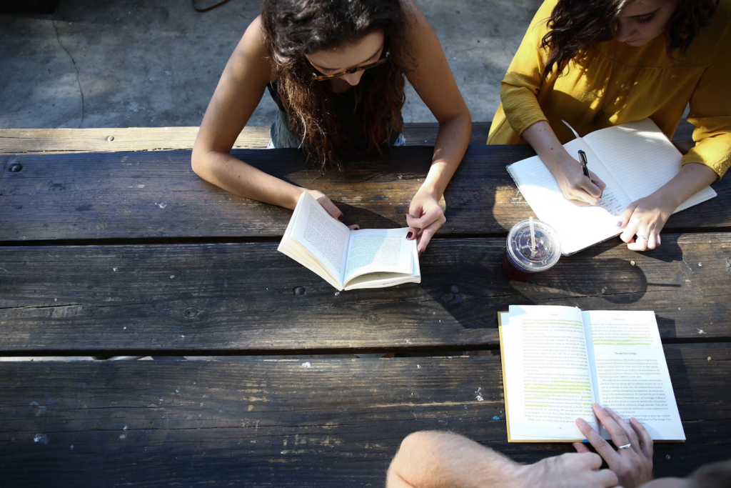 People on a table reading