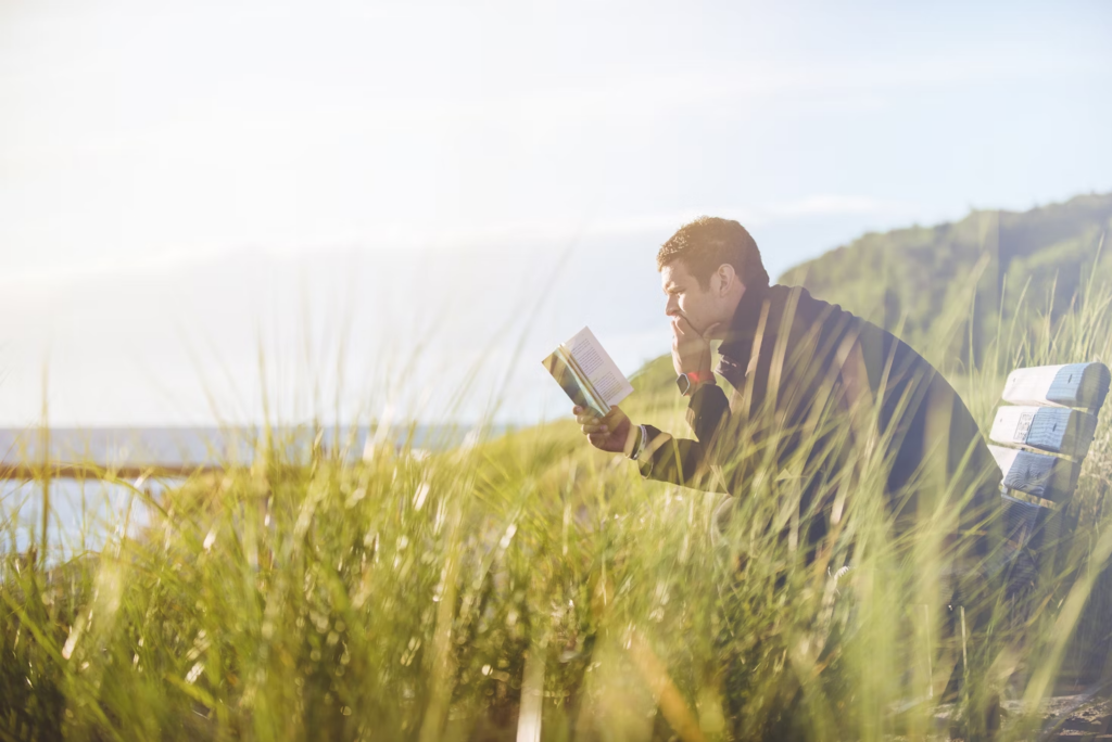 Man on a bench reading